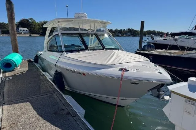 Slide: The Image of 2021 Pursuit DC 266 Dual Console boat docked at marina on a sunny day. - 0