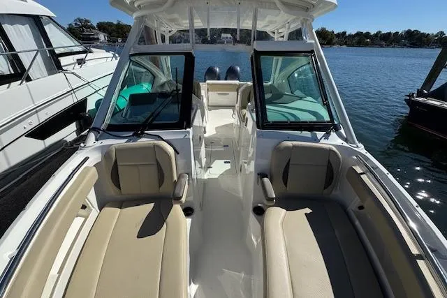 Slide: The Image of 2021 Pursuit DC 266 Dual Console boat with spacious seating on a sunny day. - 16