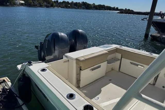 Slide: The Image of 2021 Pursuit DC 266 Dual Console boat with twin engines on a sunny lake. - 3