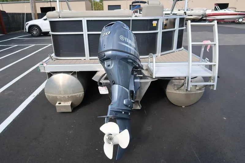 Slide: The Image of 2020 Bennington 21 SL pontoon boat with Yamaha outboard motor in a parking lot. - 10