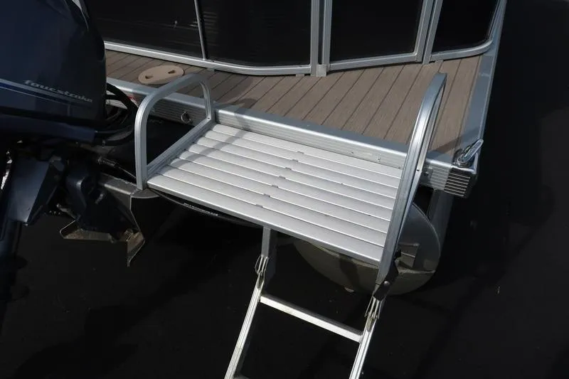 Slide: The Image of 2020 Bennington 21 SL boat with aluminum swim ladder and motor. - 12