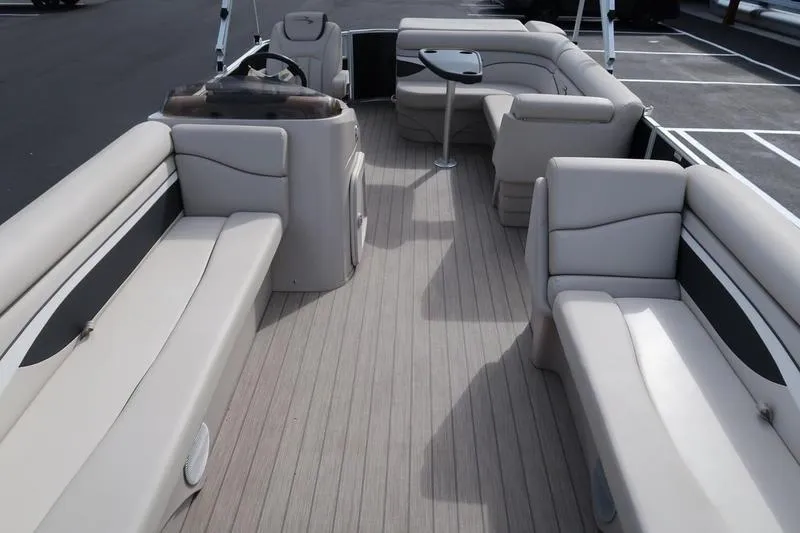 Slide: The Image of 2020 Bennington 21 SL pontoon boat interior with beige seating and wood-style flooring. - 15