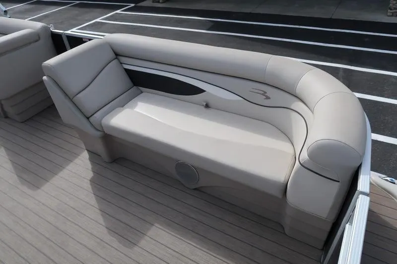 Slide: The Image of 2020 Bennington 21 SL boat interior with beige seating and stylish design. - 16