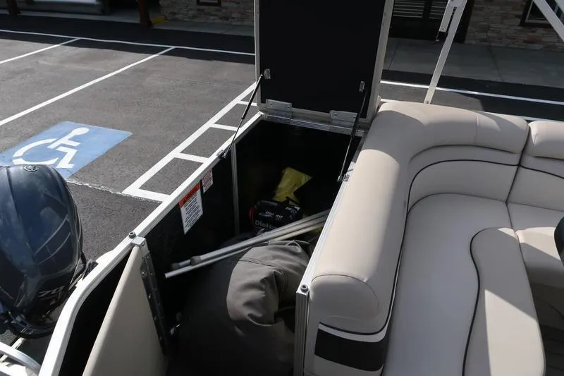 Slide: The Image of 2020 Bennington 21 SL boat storage compartment with seating and engine visible. - 20