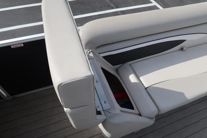 Slide: The Image of 2020 Bennington 21 SL boat seat with storage compartment open. - 21