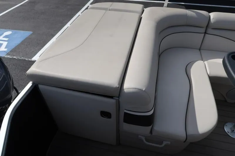 Slide: The Image of 2020 Bennington 21 SL boat interior with beige seating and storage compartment. - 23