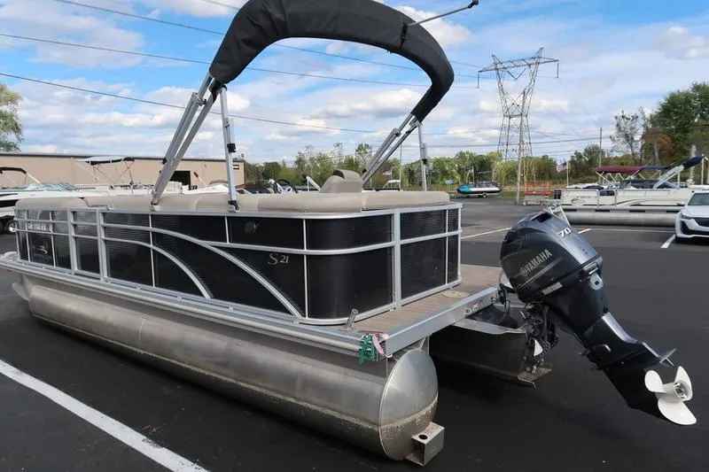 Slide: The Image of 2020 Bennington 21 SL pontoon boat with Yamaha motor in parking lot. - 4