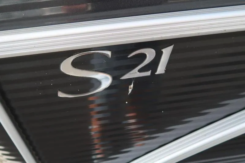 Slide: The Image of Close-up of 2020 Bennington 21 SL boat model emblem on black surface. - 7