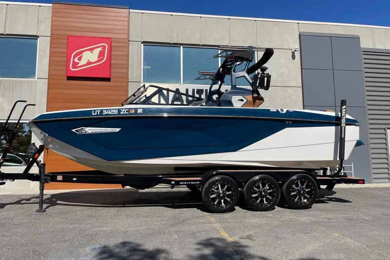 Slide: The Image of 2021 Nautique Super Air Nautique G23 boat on trailer outside dealership. - 1