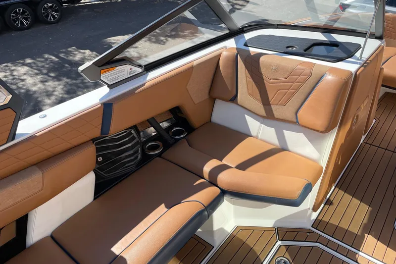 Slide: The Image of 2021 Nautique Super Air Nautique G23 interior with tan leather seating and sleek design. - 10