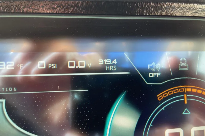 Slide: The Image of Dashboard display of a 2021 Nautique Super Air Nautique G23 showing 319.4 hours. - 13