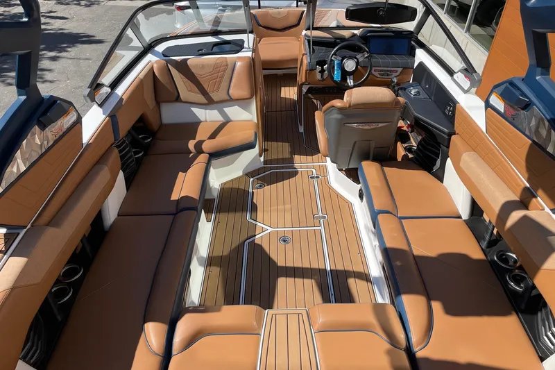 Slide: The Image of 2021 Nautique Super Air Nautique G23 interior with luxurious tan seating and sleek design. - 5