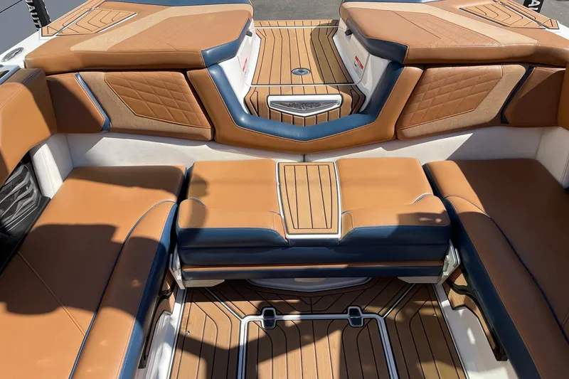 Slide: The Image of 2021 Nautique Super Air Nautique G23 interior with tan and blue seating. - 8