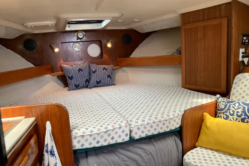 Slide: The Image of 1995 Luhrs Open Express cabin interior with cozy bedding and wooden accents. - 10