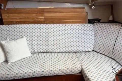 Slide: The Image of 1995 Luhrs Open Express interior with patterned sofa and wooden cabinetry. - 11