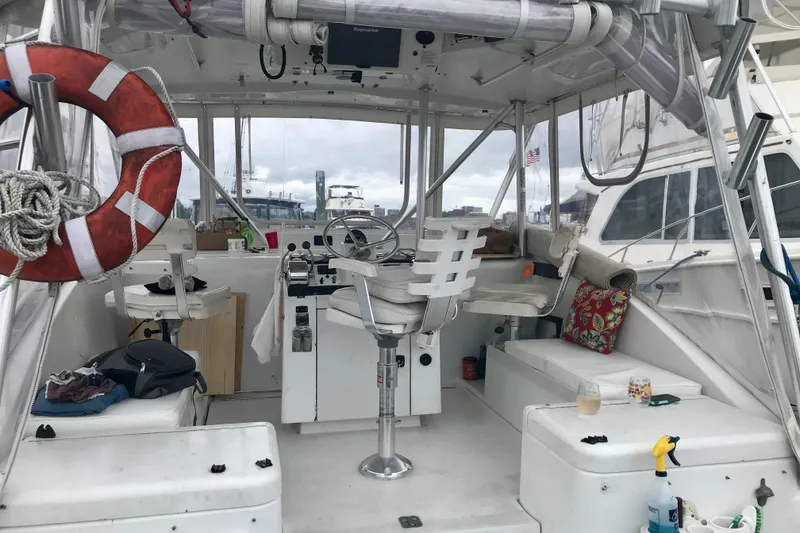 Slide: The Image of 1995 Luhrs Open Express boat interior with steering wheel, life preserver, and seating area. - 21