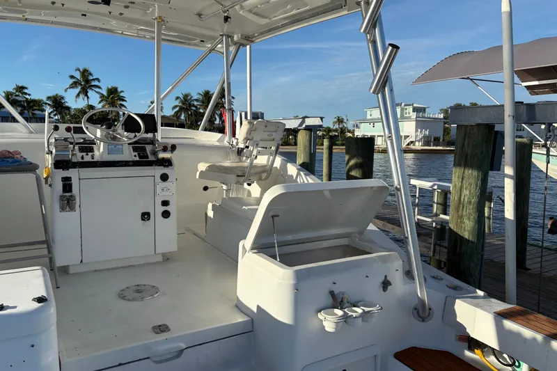 Slide: The Image of 1995 Luhrs Open Express boat interior with helm, seating, and dockside view. - 25