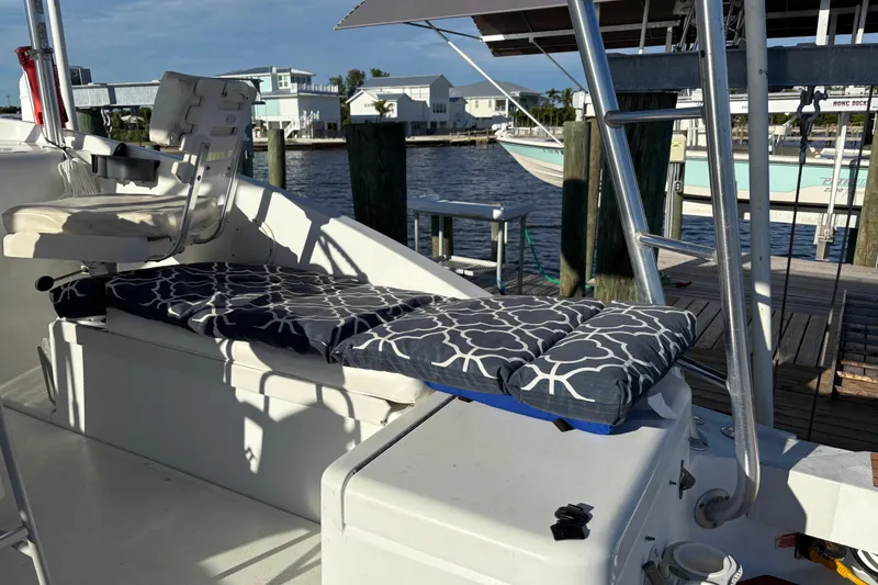 Slide: The Image of 1995 Luhrs Open Express boat with cushioned seating and dockside view. - 33