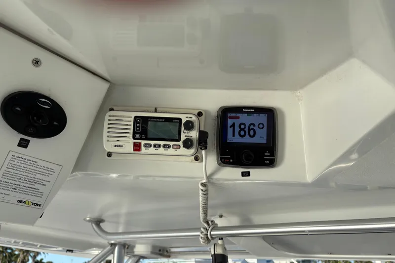 Slide: The Image of 1995 Luhrs Open Express boat dashboard with navigation and communication equipment. - 35