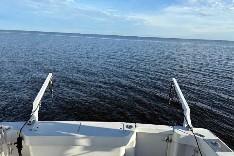 Slide: The Image of 1995 Luhrs Open Express boat deck overlooking calm ocean waters. - 5