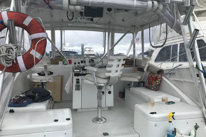 Slide: The Image of 1995 Luhrs Open Express boat interior with steering wheel, seating, and life preserver. - 9