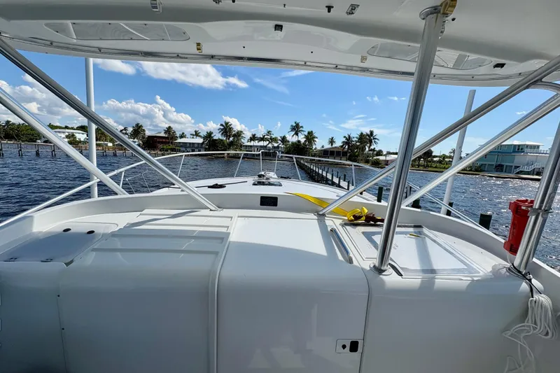 Slide: The Image of 1995 Luhrs Open Express boat on water, with palm trees and blue sky in the background. - 23