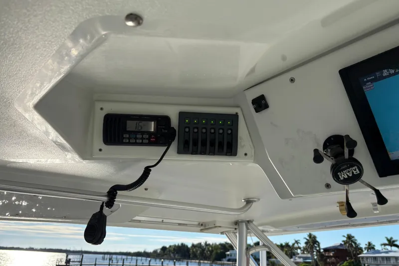 Slide: The Image of 1995 Luhrs Open Express boat dashboard with radio and navigation equipment. - 32