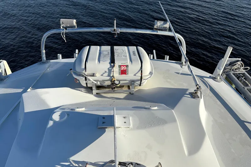 Slide: The Image of 1995 Luhrs Open Express boat deck with life raft, on calm water. - 38