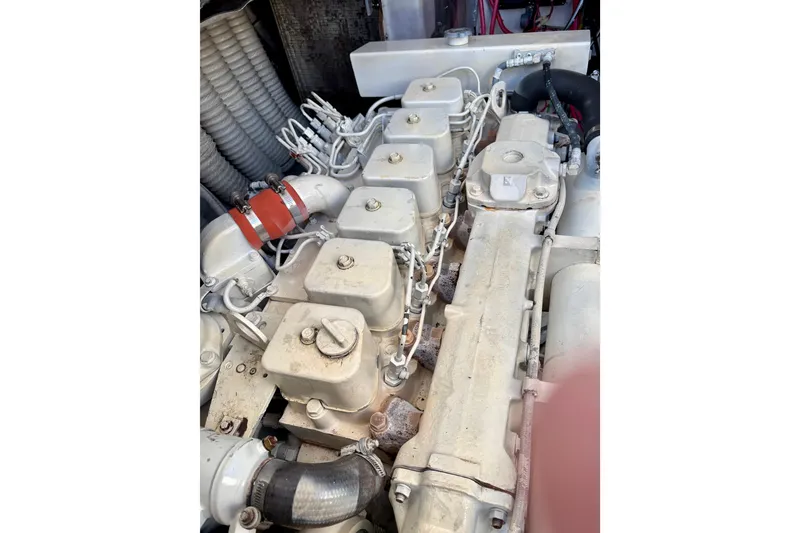 Slide: The Image of Engine of a 1995 Luhrs Open Express boat, showcasing mechanical components and hoses. - 40