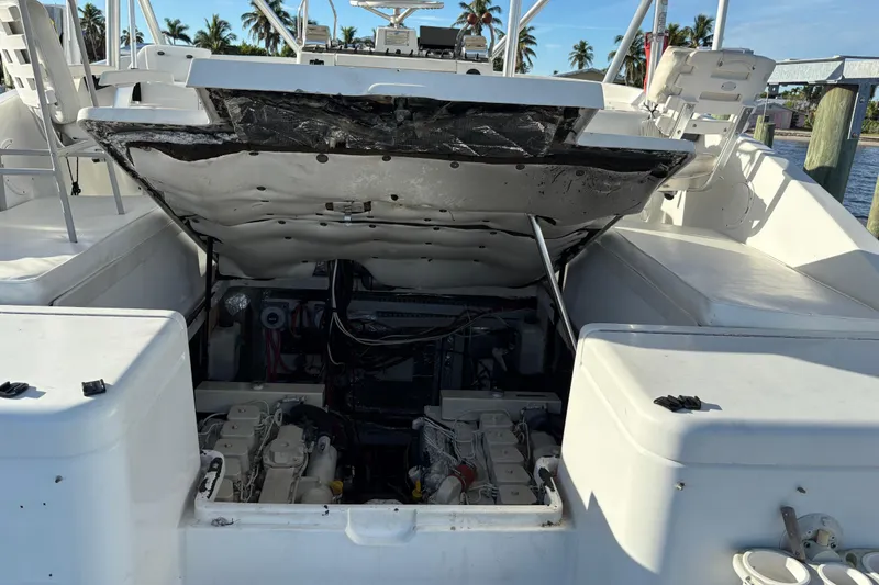 Slide: The Image of 1995 Luhrs Open Express boat engine compartment with open hatch, docked near palm trees. - 42