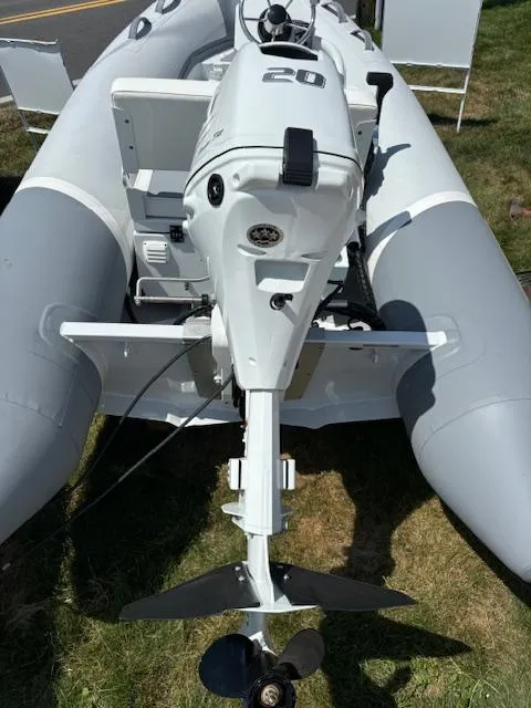 Slide: The Image of 2024 Inmar 325R-AL inflatable boat with outboard motor, displayed outdoors. - 5