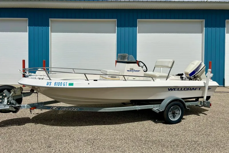Slide: The Image of Trailer wheel of a 1997 Wellcraft 160 Fisherman boat on pavement. - 19
