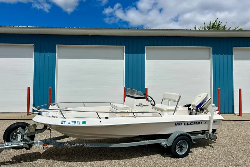 Slide: The Image of 1997 Wellcraft 160 Fisherman boat on trailer, parked in front of blue garage doors. - 20