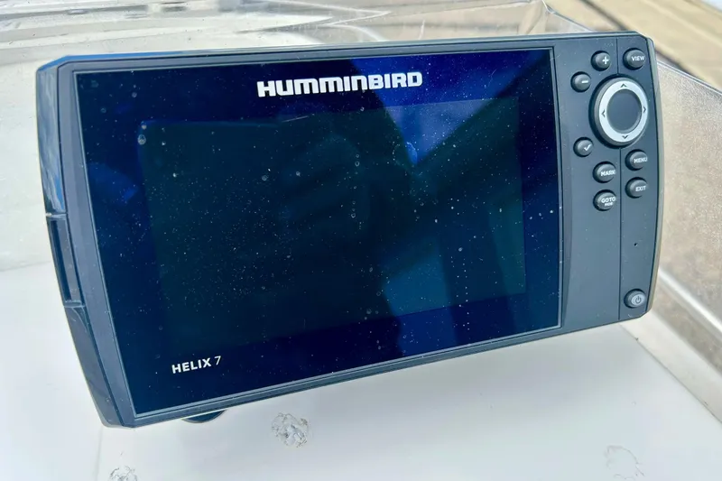 Slide: The Image of 1997 Wellcraft 160 Fisherman boat console with steering wheel and Humminbird device. - 23