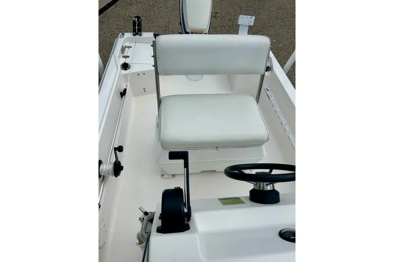 Slide: The Image of 1997 Wellcraft 160 Fisherman boat interior with white seating and railings. - 25