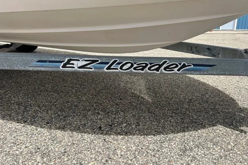 Slide: The Image of 1997 Wellcraft 160 Fisherman boat on trailer, parked on gravel surface. - 3