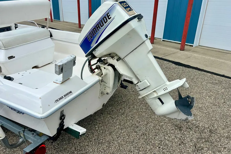 Slide: The Image of 1997 Wellcraft 160 Fisherman boat with Evinrude outboard motor on trailer. - 32