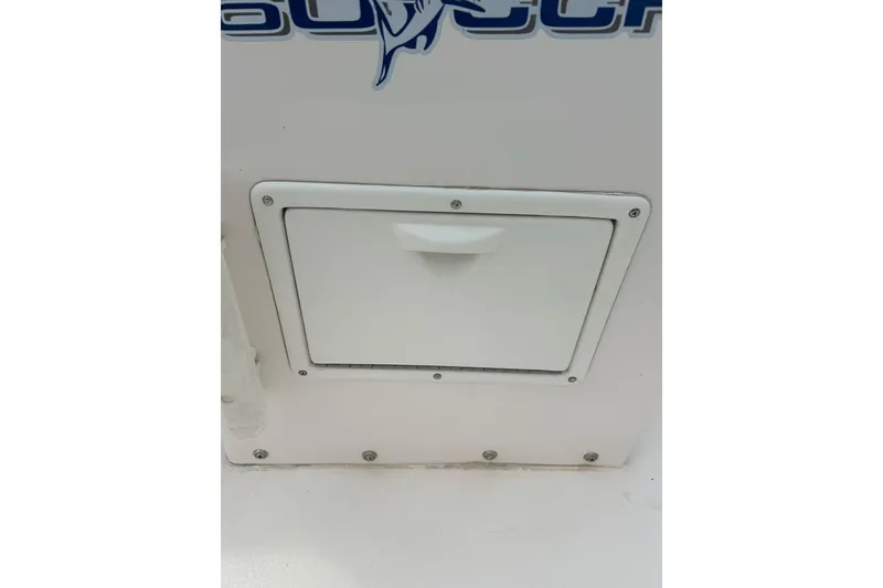 Slide: The Image of Storage compartment on a 1997 Wellcraft 160 Fisherman boat, featuring a hinged door. - 9