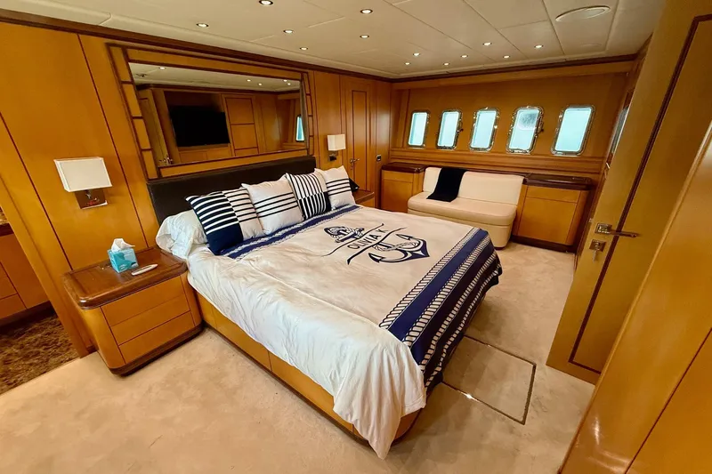 Slide: The Image of Luxurious bedroom interior of 2005 Mangusta 92 yacht with nautical-themed bedding. - 11