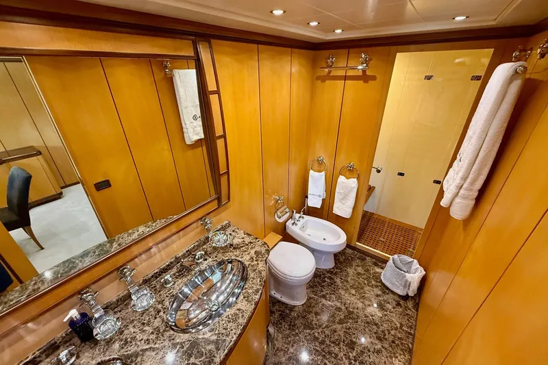 Slide: The Image of Luxurious bathroom in 2005 Mangusta 92 yacht with marble countertop and wooden paneling. - 13
