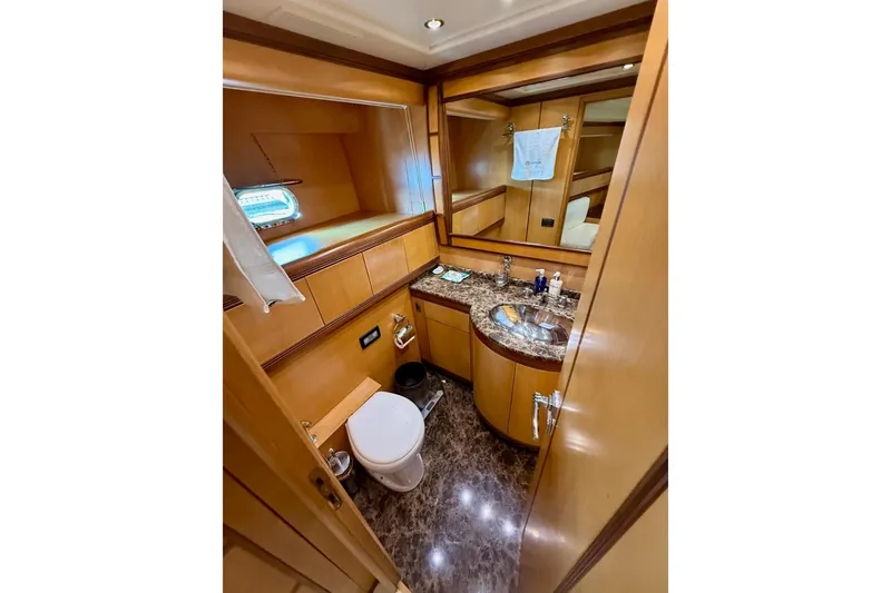 Slide: The Image of Luxurious bathroom in 2005 Mangusta 92 yacht with marble countertop and wooden cabinetry. - 15