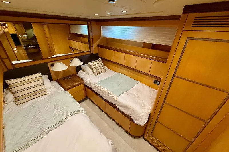 Slide: The Image of Luxurious twin cabin interior of 2005 Mangusta 92 yacht with wooden furnishings. - 16