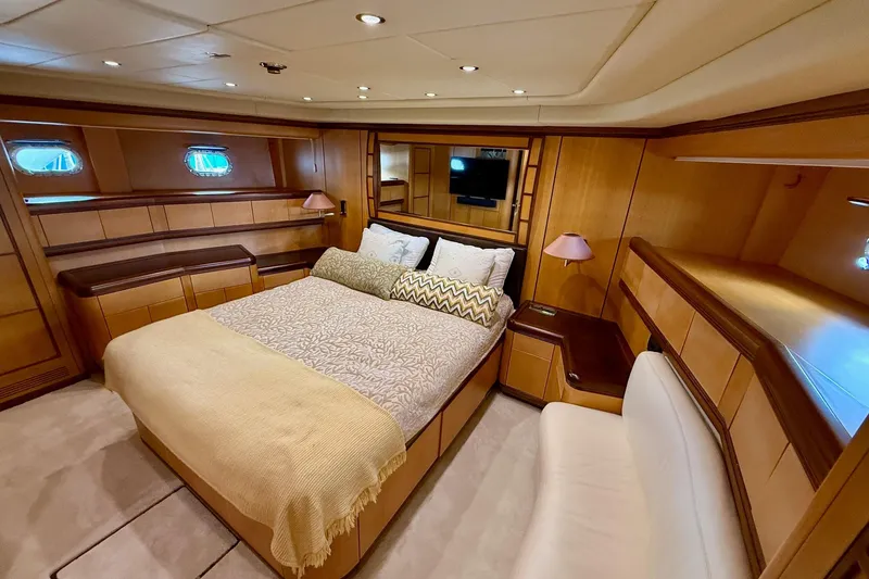 Slide: The Image of Luxurious bedroom interior of 2005 Mangusta 92 yacht with elegant wood paneling. - 18