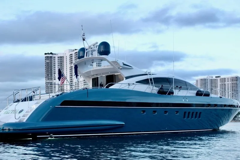 Slide: The Image of Luxurious 2005 Mangusta 92 yacht docked with city skyline backdrop. - 2