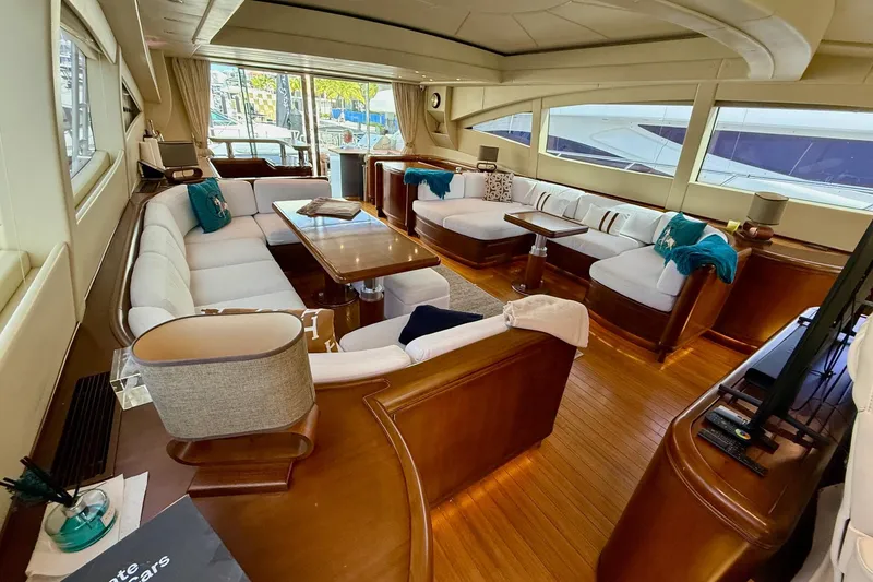 Slide: The Image of Luxurious interior of a 2005 Mangusta 92 yacht with elegant seating and wooden accents. - 6
