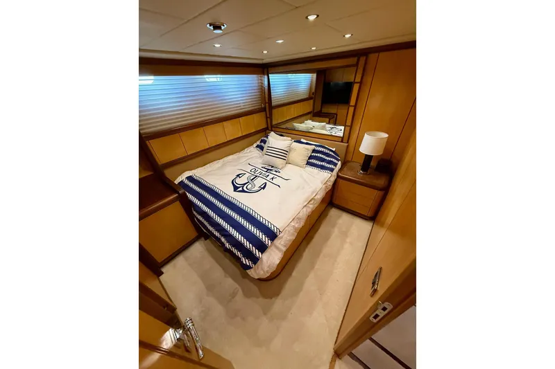 Slide: The Image of Luxurious bedroom interior of 2005 Mangusta 92 yacht with nautical-themed bedding. - 9
