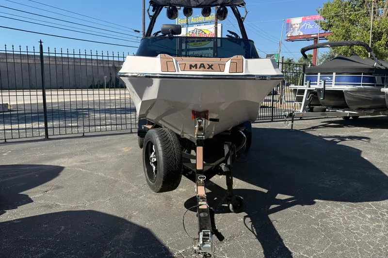 Slide: The Image of 2021 Moomba Max boat on trailer in outdoor dealership lot. - 1