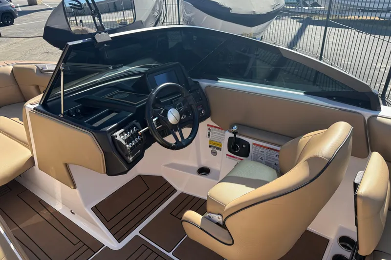 Slide: The Image of 2021 Moomba Max boat interior with tan seats and modern dashboard controls. - 10