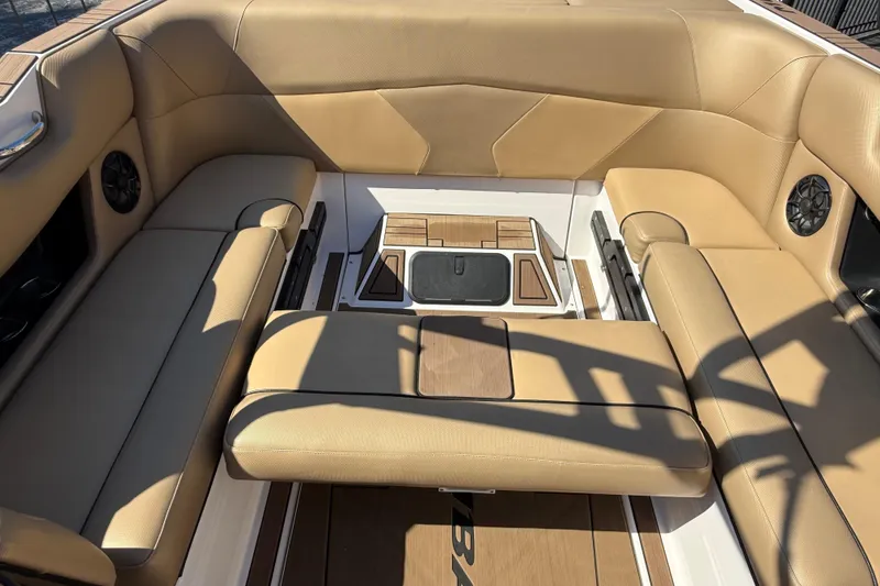 Slide: The Image of 2021 Moomba Max boat interior with tan seating and integrated speakers. - 14