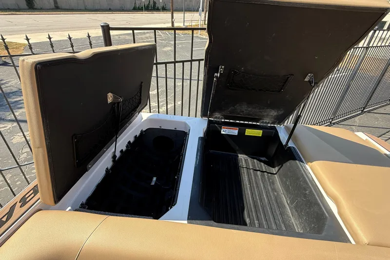 Slide: The Image of 2021 Moomba Max boat storage compartments open, showcasing interior space. - 15